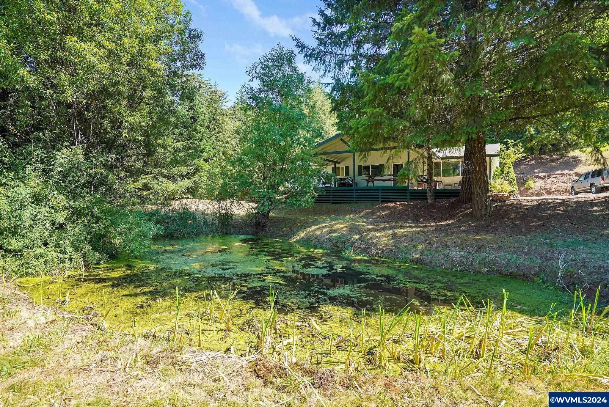 1787 Cochrane Lane Dallas, OR 97338 - Photo 1 of 42 a front view of a house with a yard table and chairs