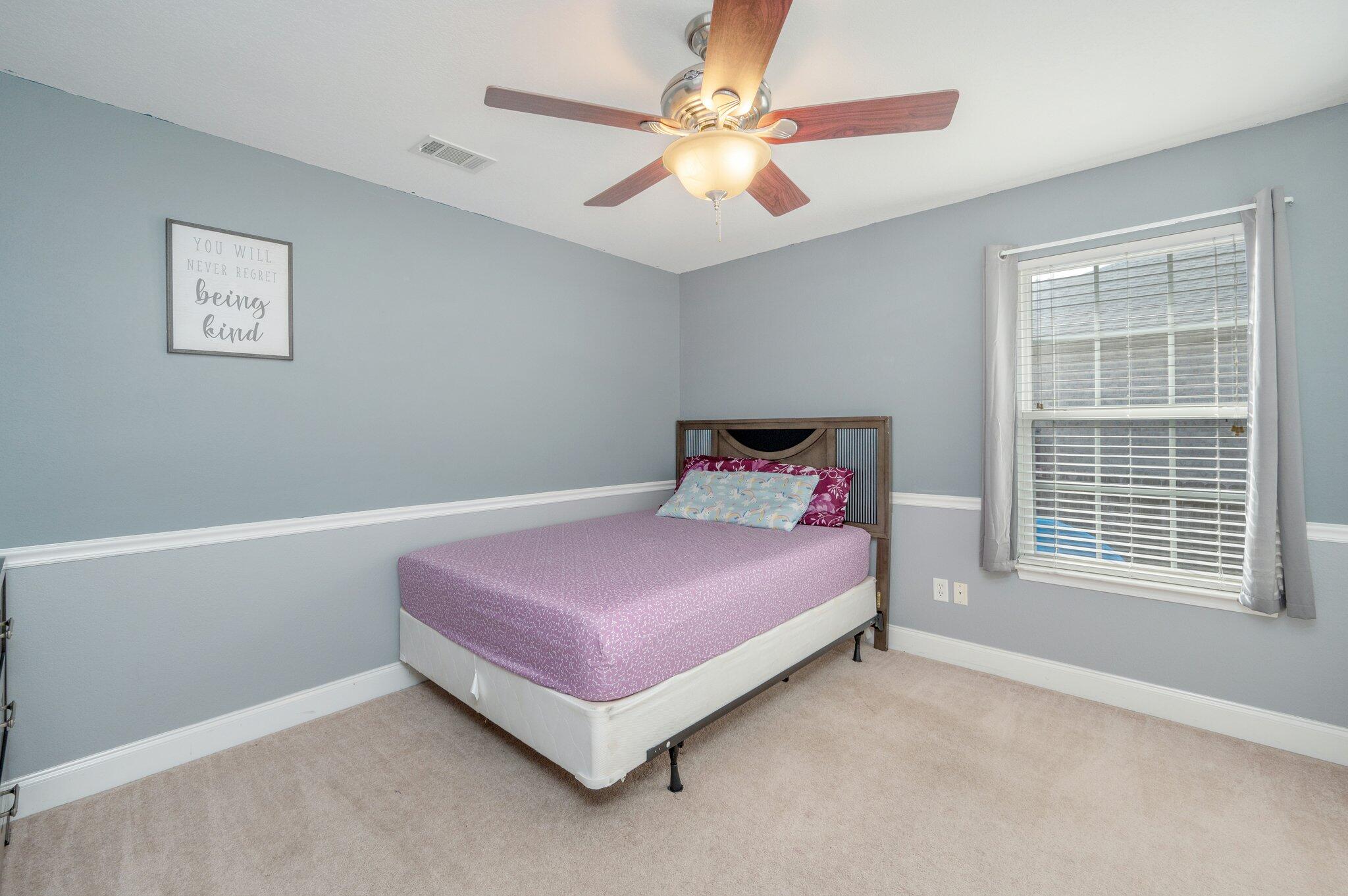 730 Riva Ridge Drive Crestview, FL 32539 - Photo 23 of 29 a bedroom with a bed and a ceiling fan
