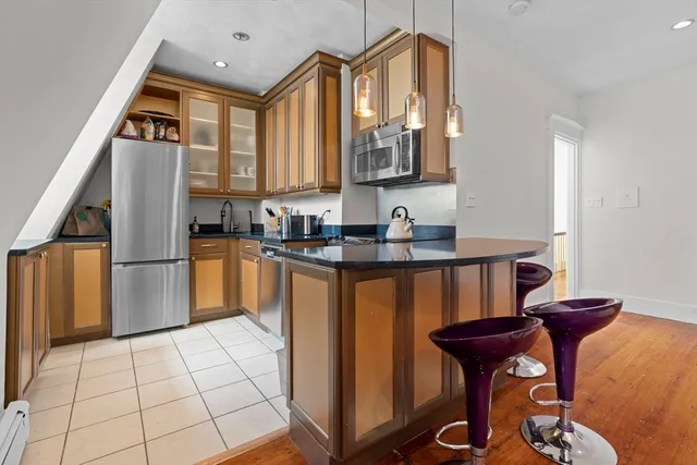 a kitchen with sink a refrigerator and cabinets