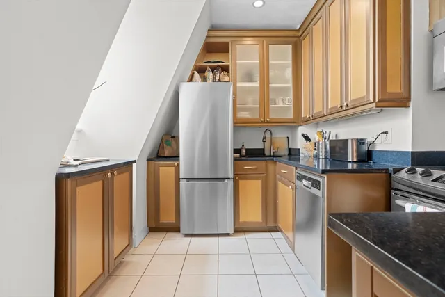 a kitchen with a refrigerator a stove a microwave and cabinets