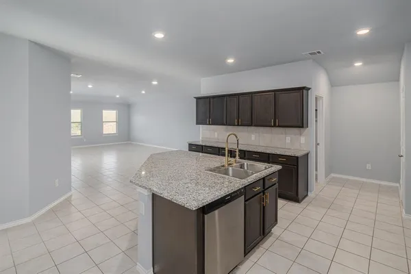 a kitchen with stainless steel appliances granite countertop a sink and a stove
