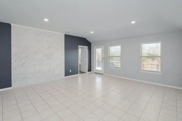 an empty room with windows and closet