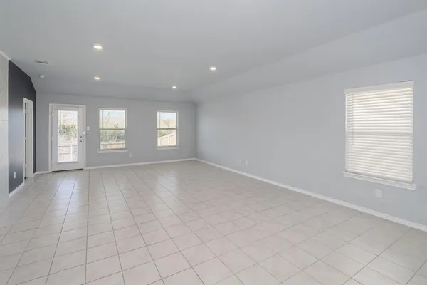 a view of empty room with window and hardwood floor