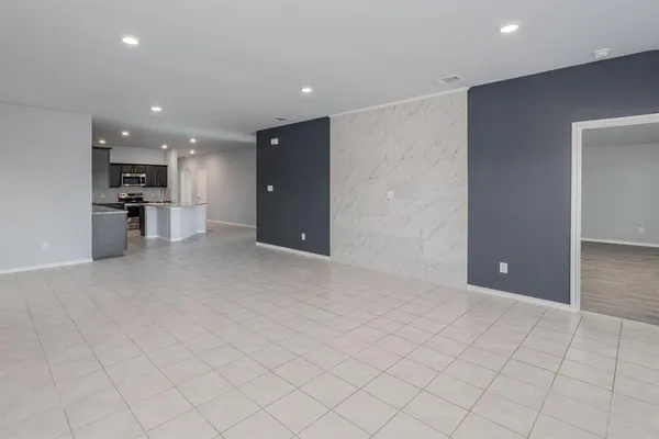 an empty room with cabinet and mirrors