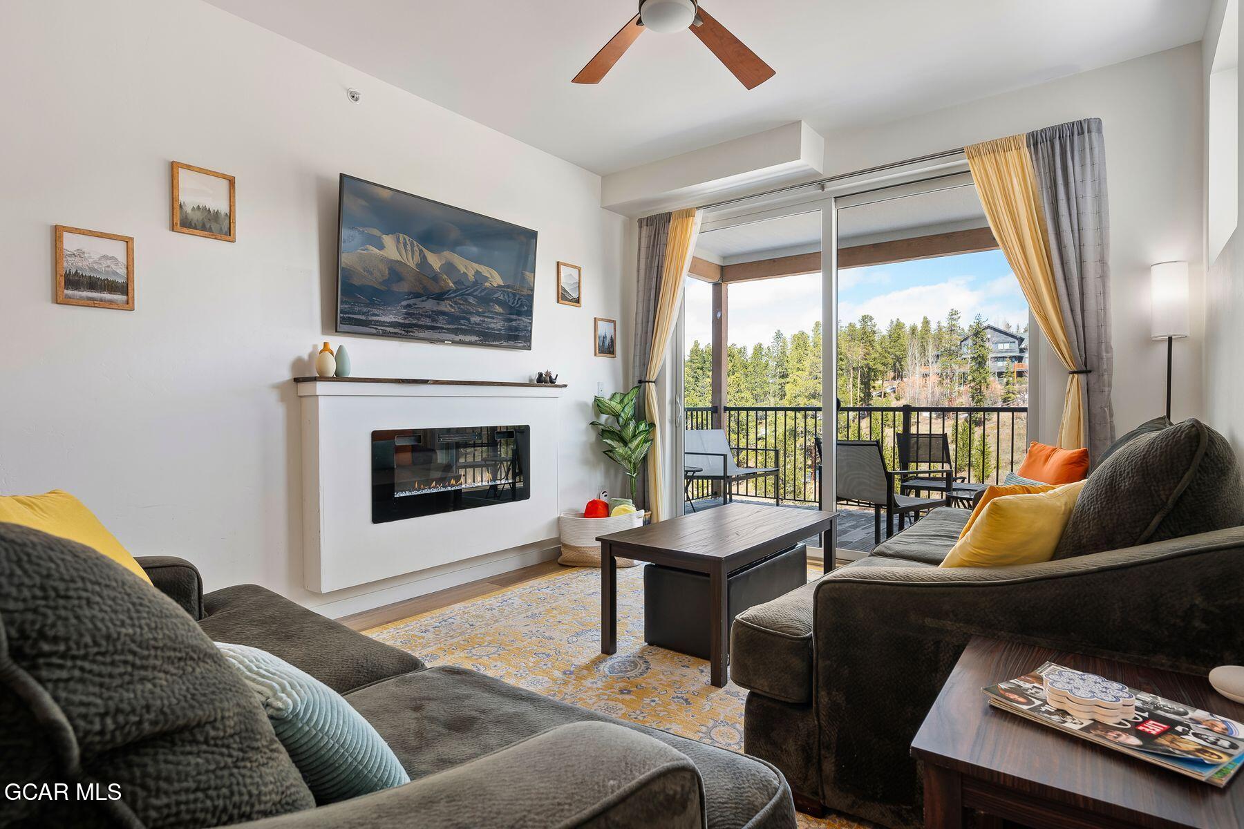 421 West Meadow Mile, Unit 3 Fraser, CO 80442 - Photo 1 of 29 a living room with furniture a flat screen tv and a fireplace