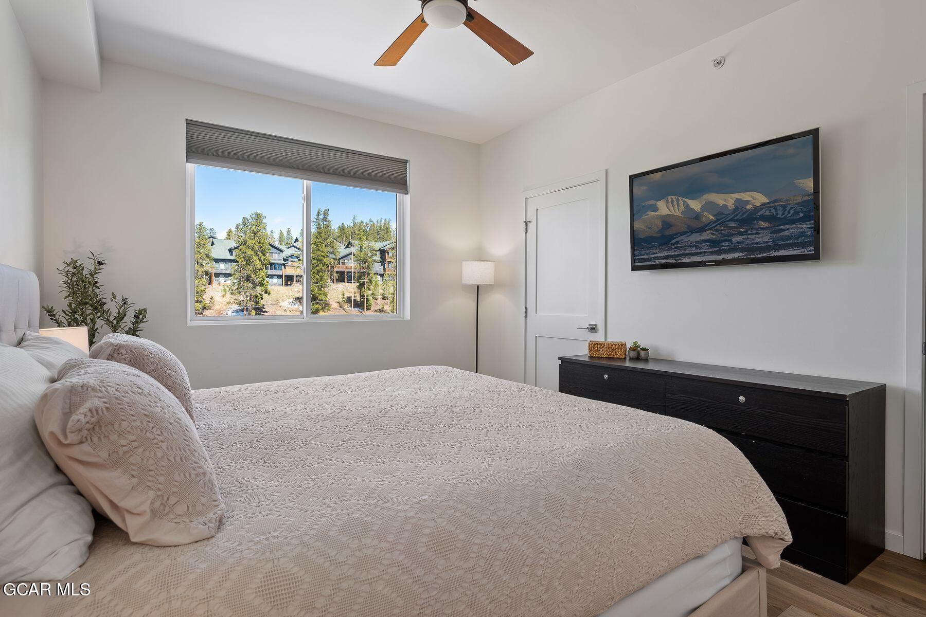 421 West Meadow Mile, Unit 3 Fraser, CO 80442 - Photo 15 of 29 a bedroom with a bed and a painting on the wall