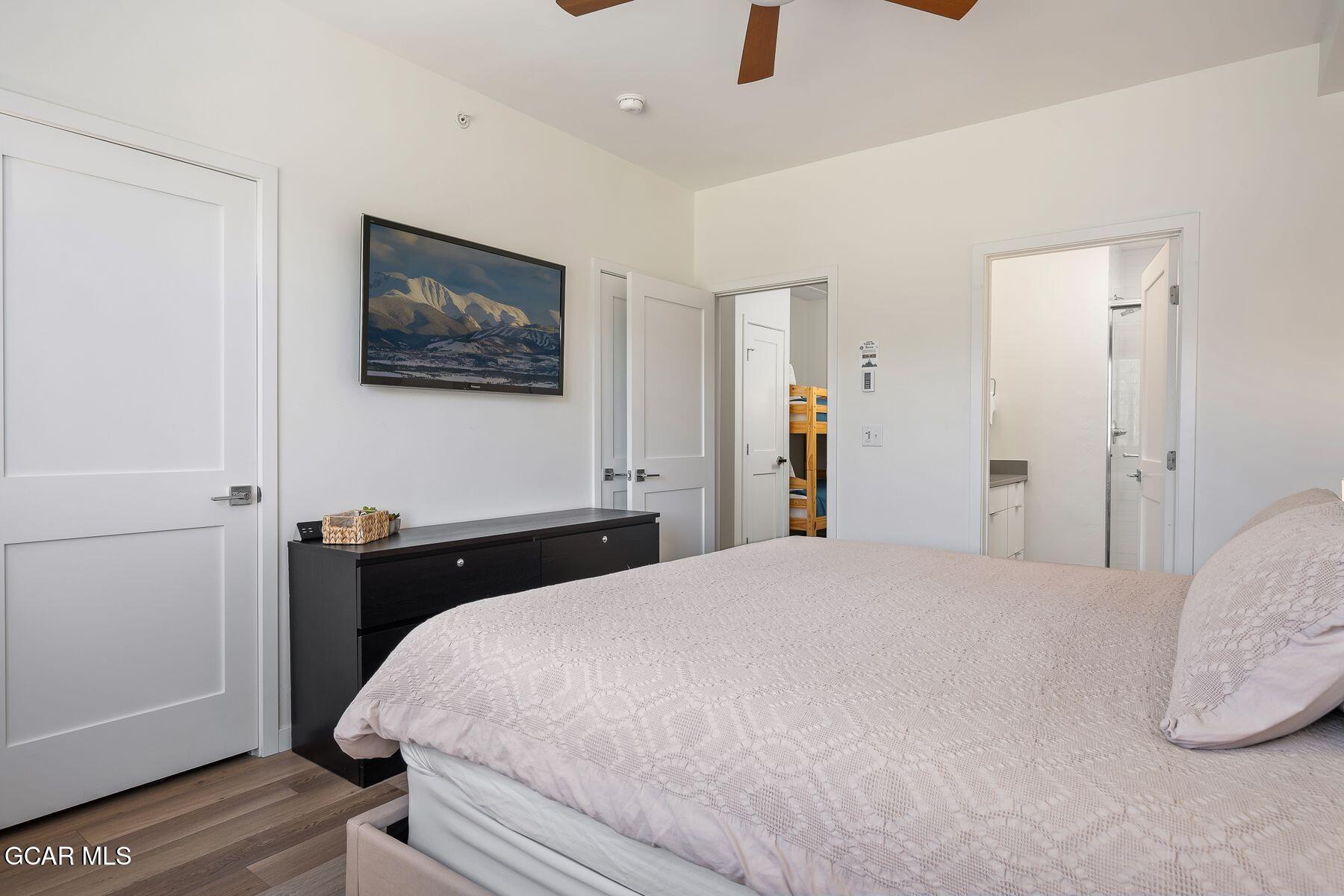 421 West Meadow Mile, Unit 3 Fraser, CO 80442 - Photo 16 of 29 a bedroom with a bed and a flat screen tv