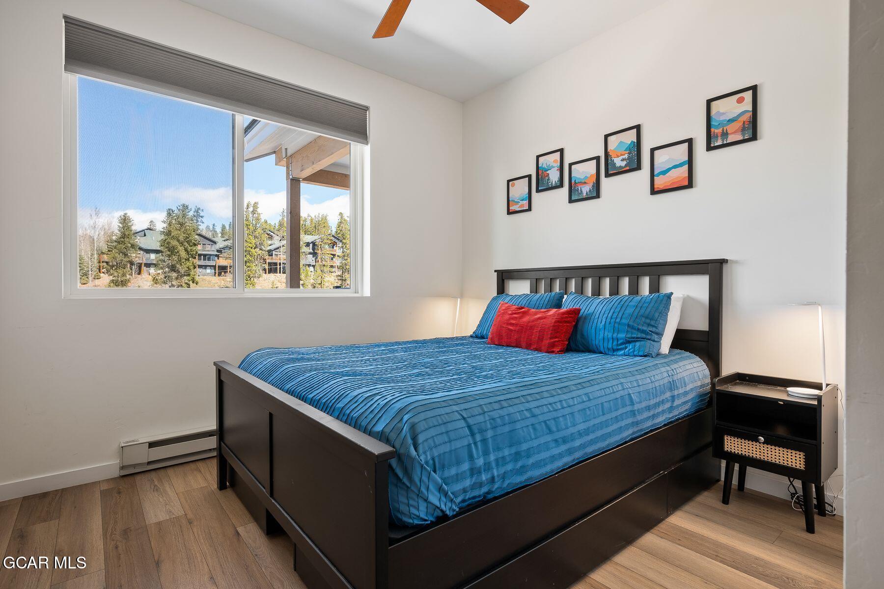 421 West Meadow Mile, Unit 3 Fraser, CO 80442 - Photo 19 of 29 a bedroom with a bed and window
