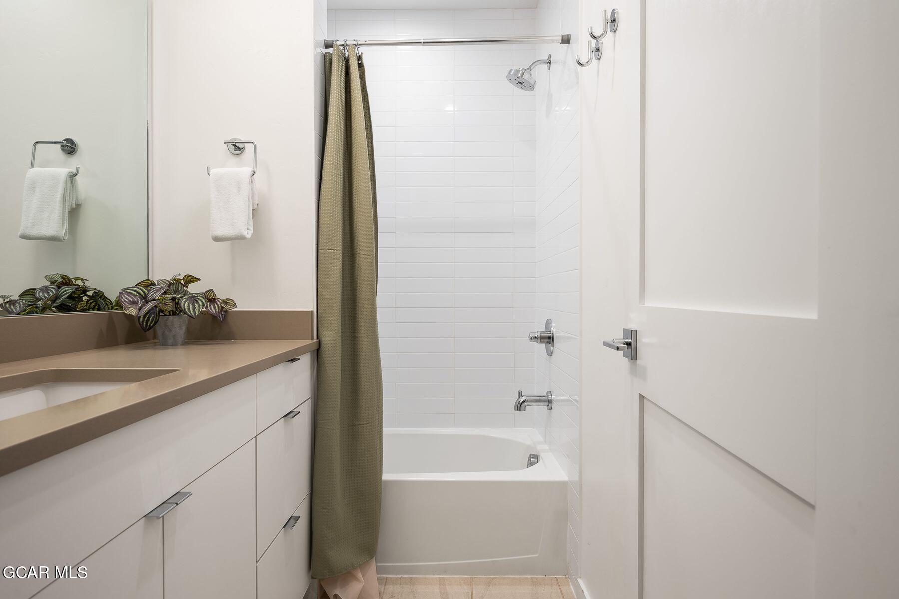 421 West Meadow Mile, Unit 3 Fraser, CO 80442 - Photo 24 of 29 a bathroom with a granite countertop sink and a mirror