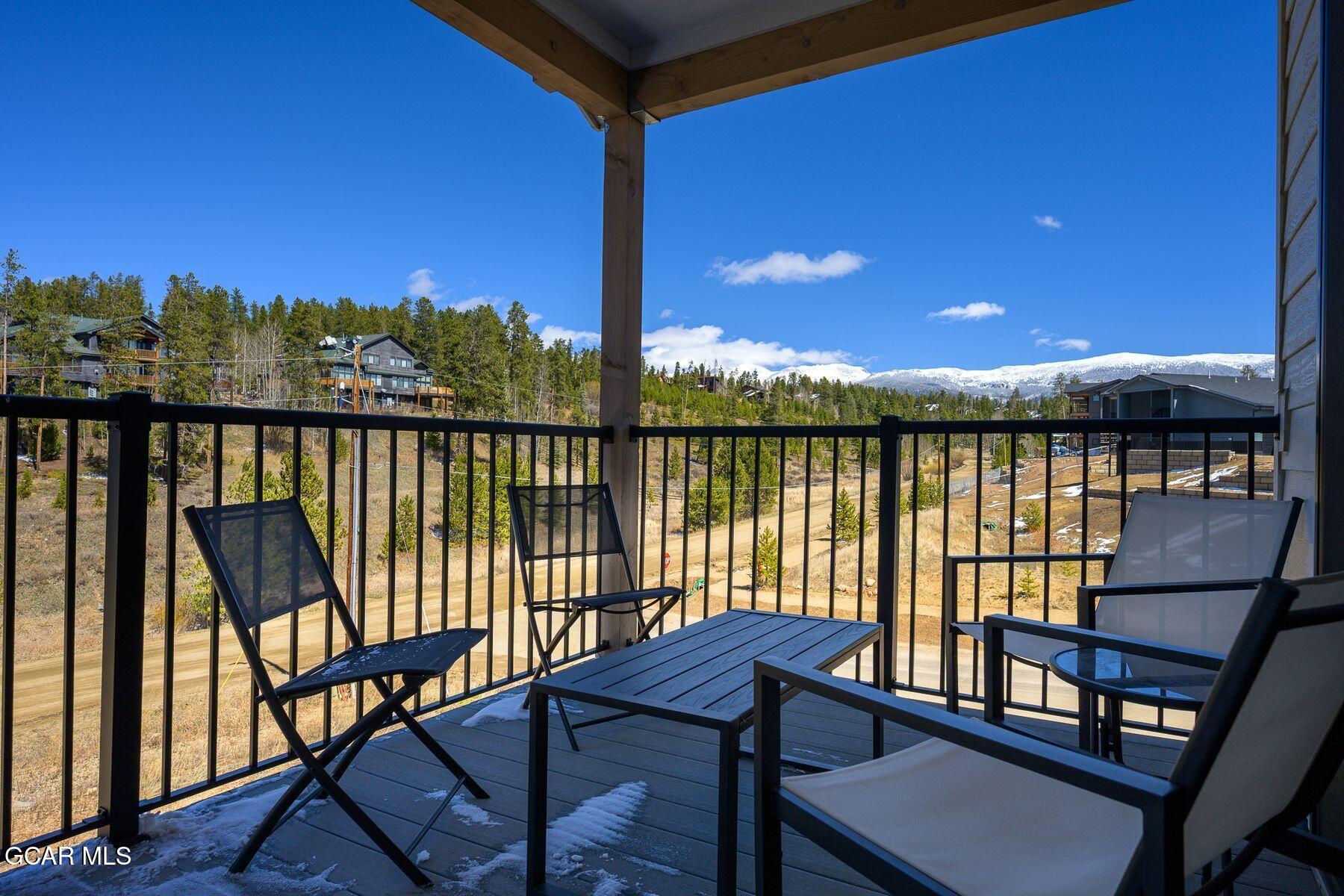 421 West Meadow Mile, Unit 3 Fraser, CO 80442 - Photo 25 of 29 a view of a balcony with chairs and wooden floor