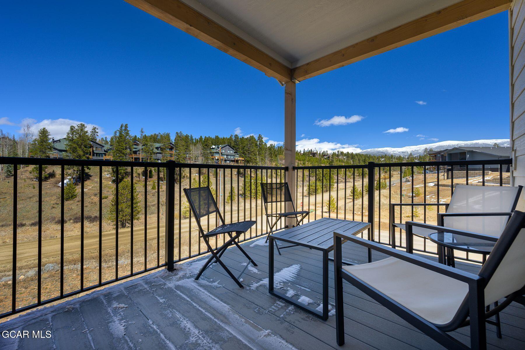 421 West Meadow Mile, Unit 3 Fraser, CO 80442 - Photo 3 of 29 a view of a balcony with chairs and wooden floor