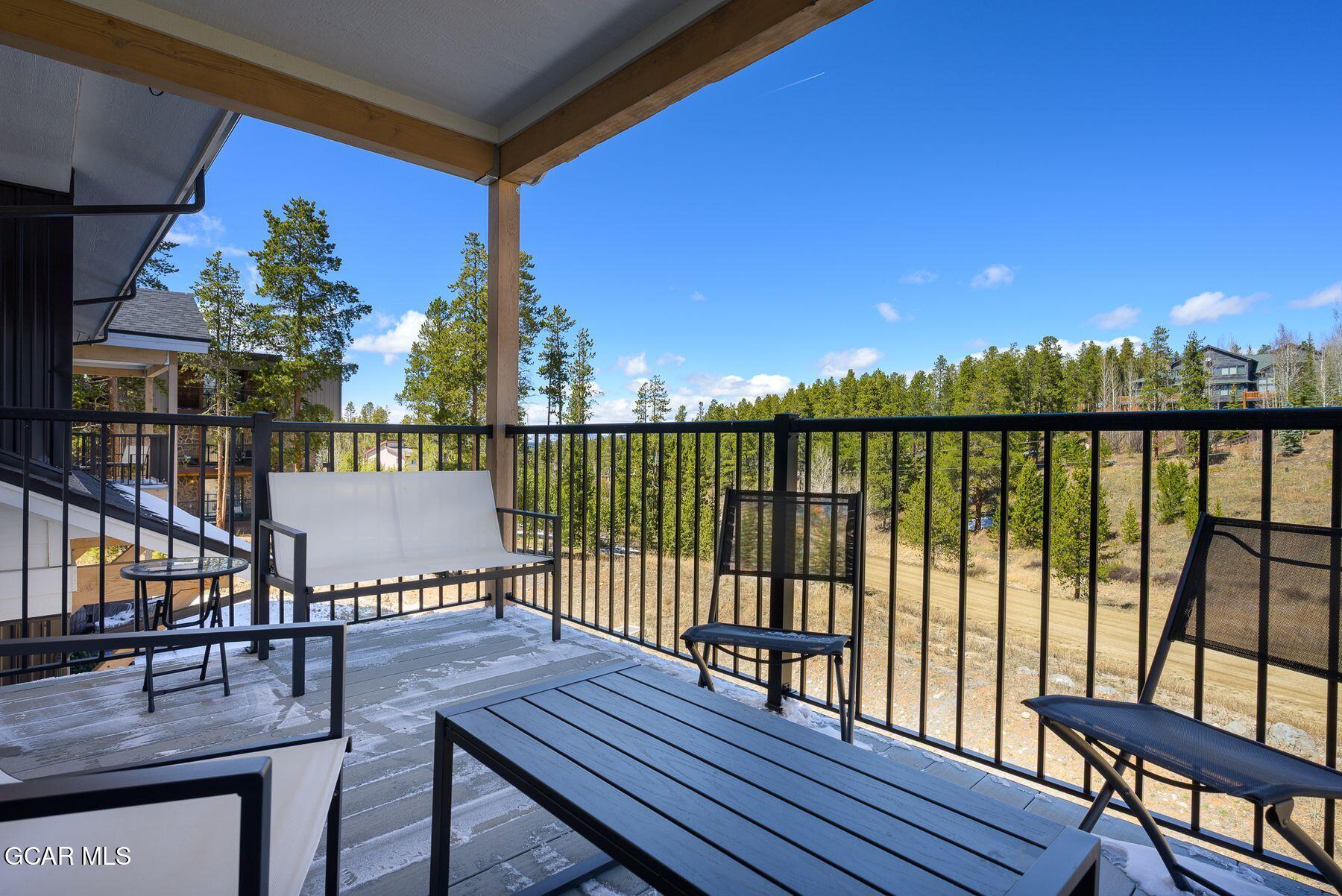 421 West Meadow Mile, Unit 3 Fraser, CO 80442 - Photo 4 of 29 a view of a balcony with wooden floor and outdoor seating