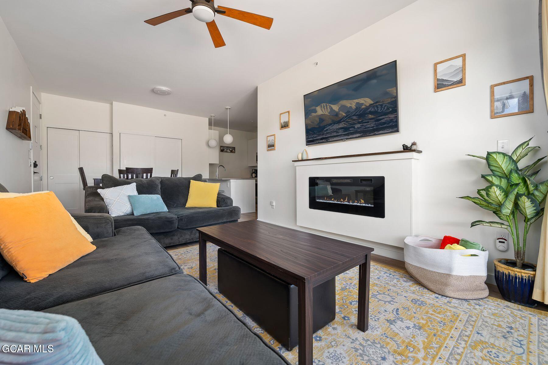 421 West Meadow Mile, Unit 3 Fraser, CO 80442 - Photo 6 of 29 a living room with furniture and a flat screen tv