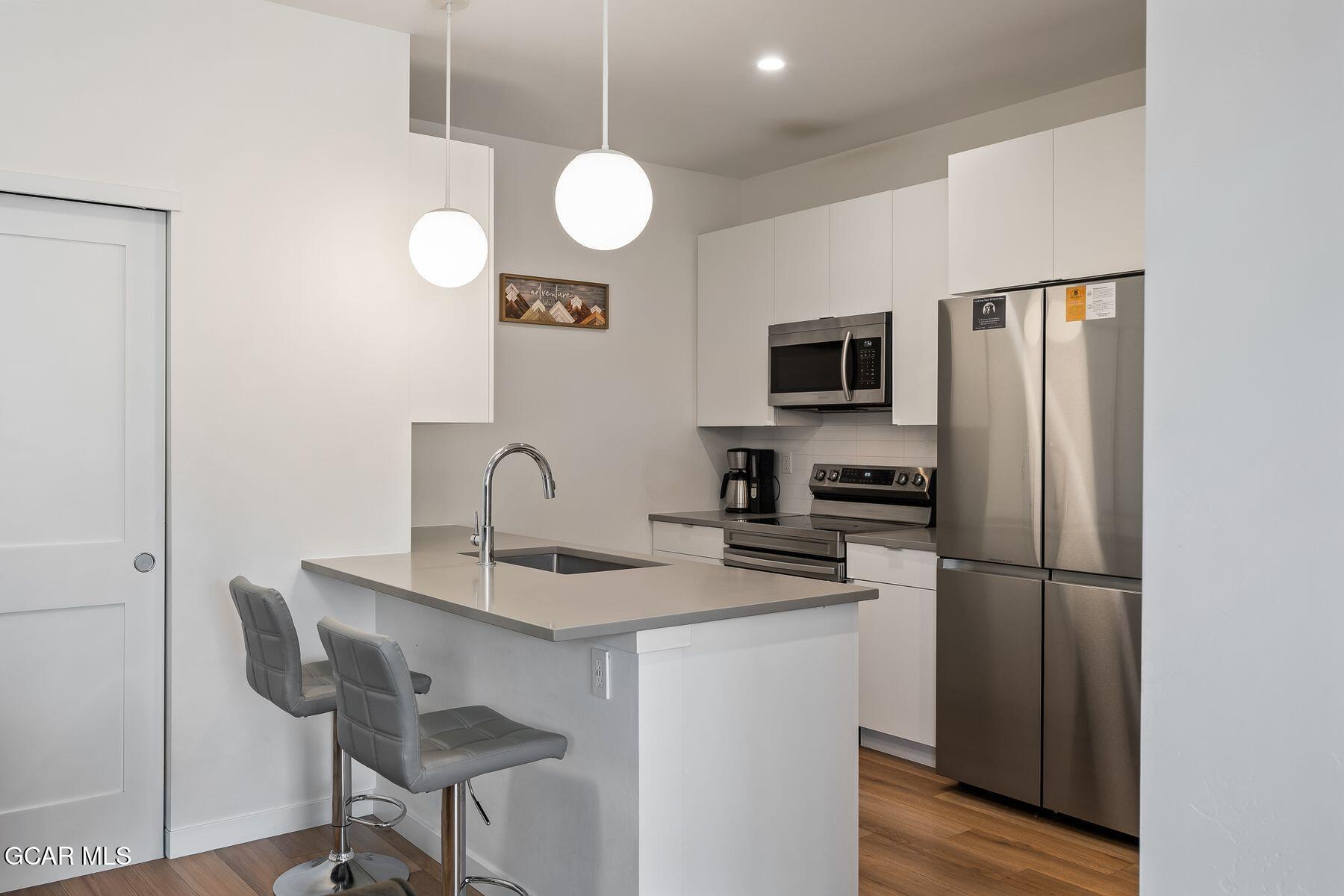 421 West Meadow Mile, Unit 3 Fraser, CO 80442 - Photo 7 of 29 a kitchen with stainless steel appliances granite countertop a refrigerator and a stove top oven