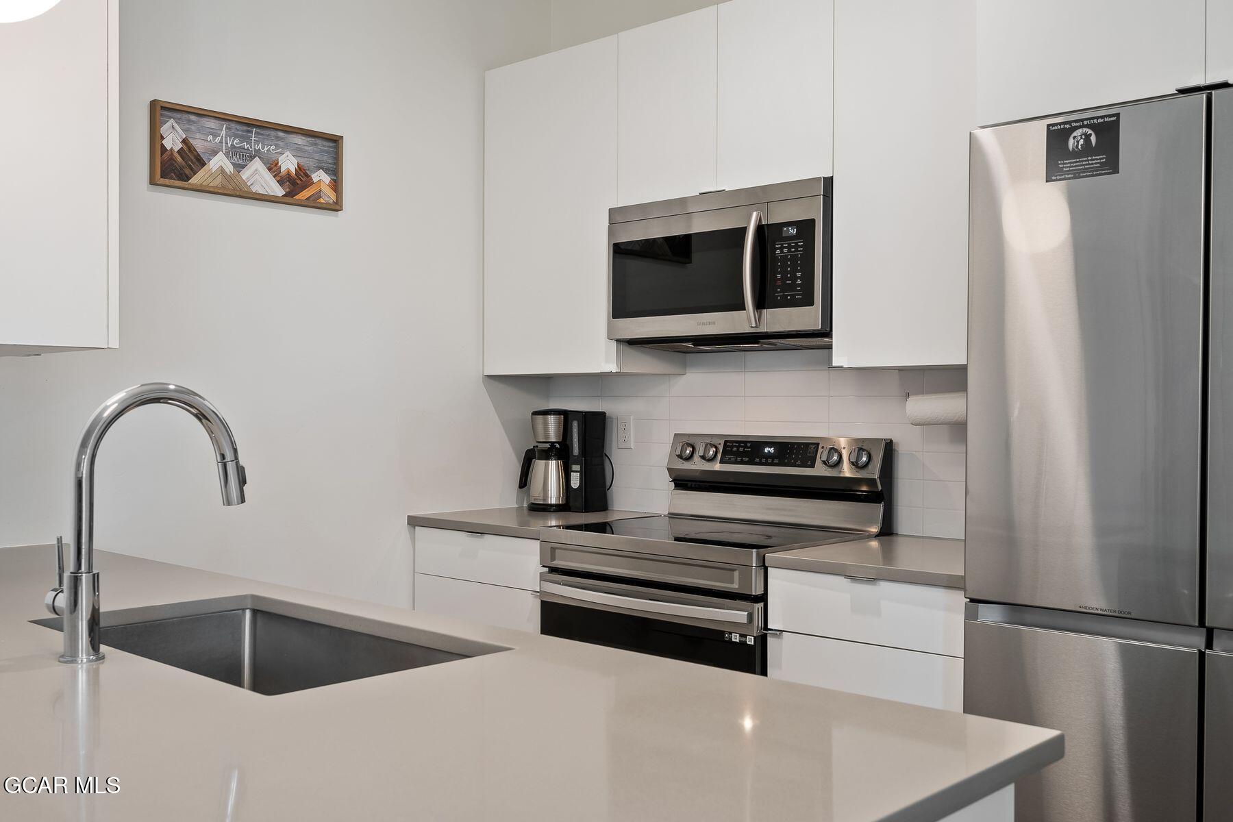 421 West Meadow Mile, Unit 3 Fraser, CO 80442 - Photo 8 of 29 a kitchen with a refrigerator and a sink