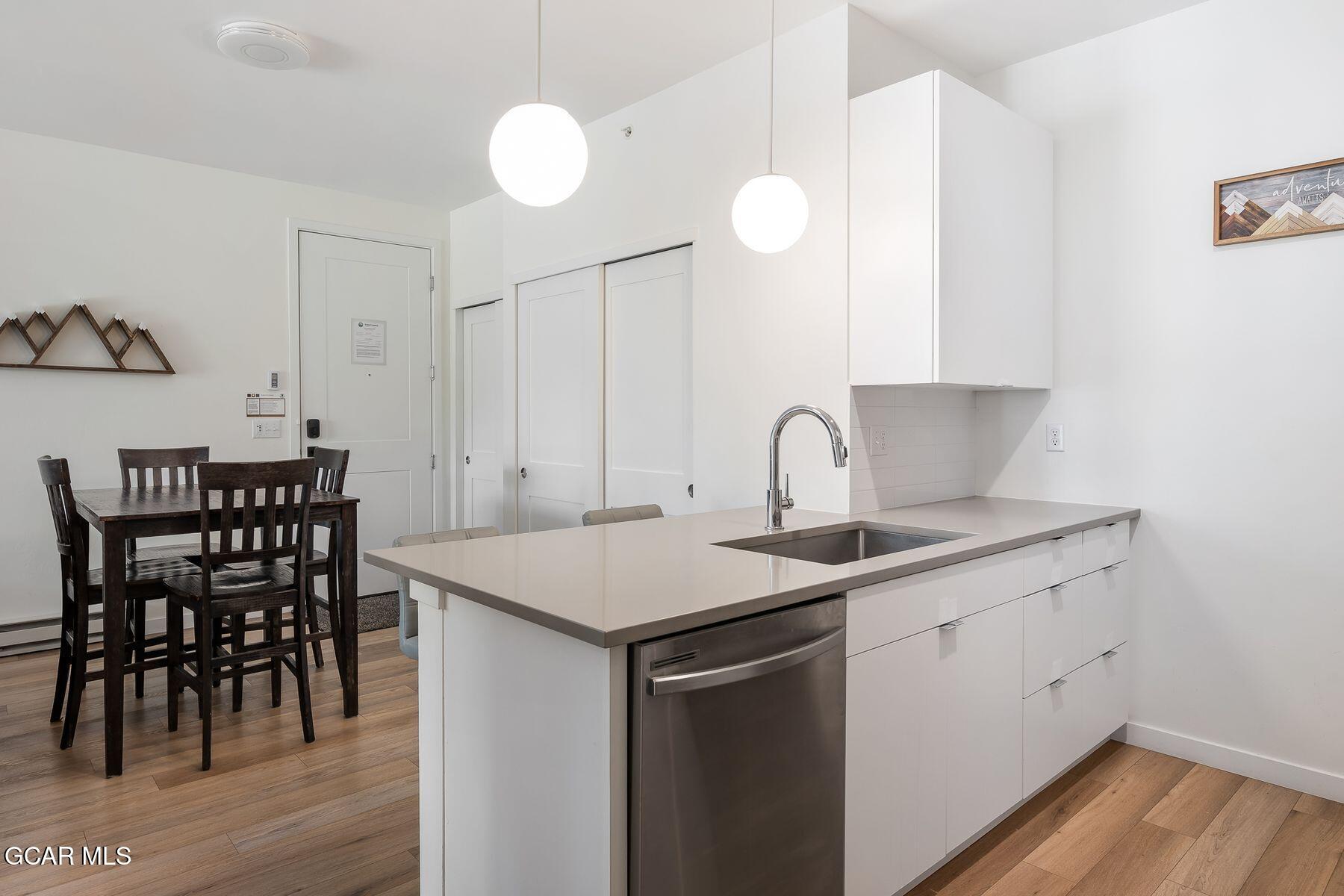 421 West Meadow Mile, Unit 3 Fraser, CO 80442 - Photo 10 of 29 a kitchen with a table chairs sink and cabinets