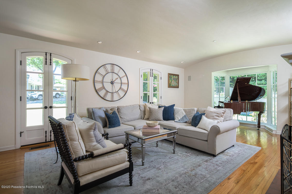 153 Sierra View Road Pasadena, CA 91105 - Photo 11 of 54 a living room with furniture a large window and a clock