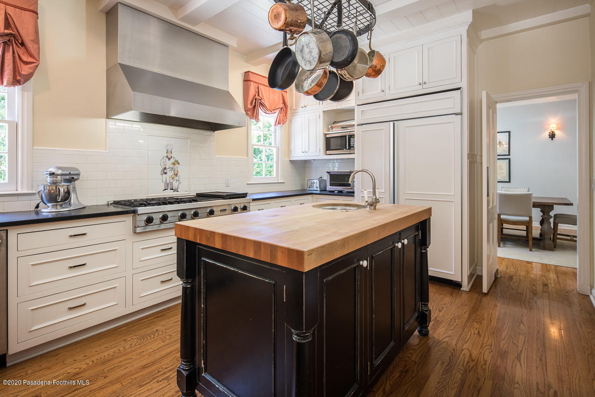 153 Sierra View Road Pasadena, CA 91105 - Photo 18 of 54 a kitchen with a sink dishwasher a stove and a microwave oven with wooden floor