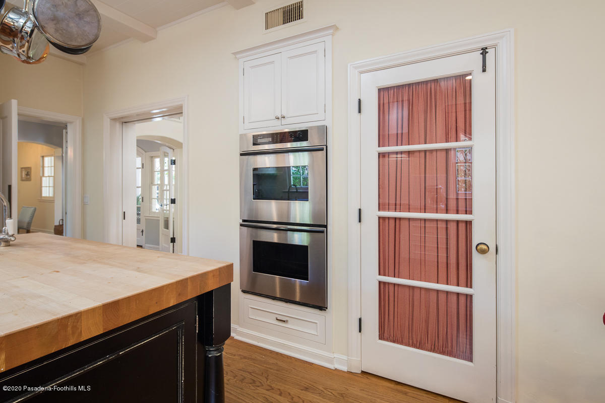 153 Sierra View Road Pasadena, CA 91105 - Photo 20 of 54 a kitchen with stainless steel appliances a refrigerator and a wooden floor
