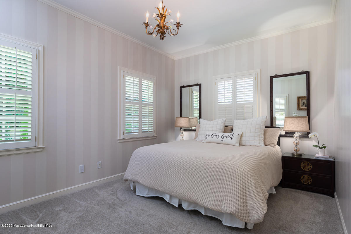 153 Sierra View Road Pasadena, CA 91105 - Photo 27 of 54 a bedroom with a bed and a chandelier