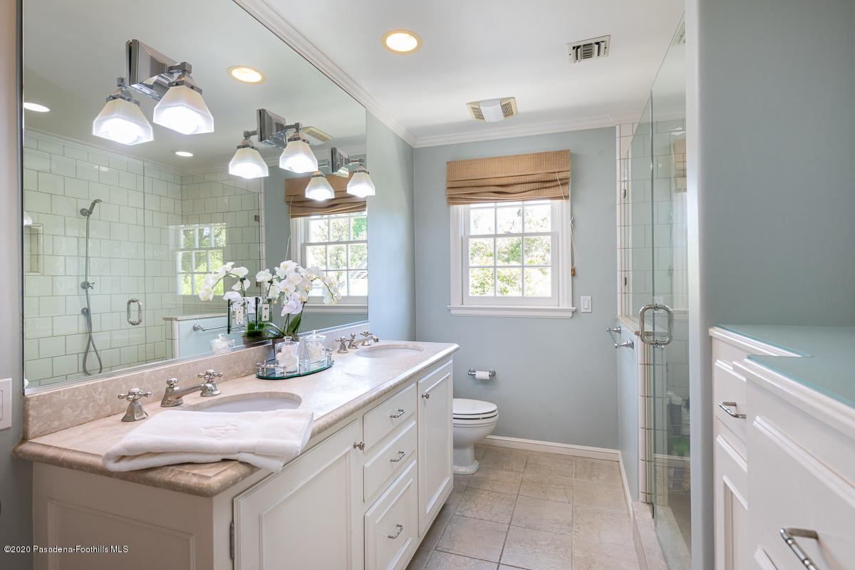 153 Sierra View Road Pasadena, CA 91105 - Photo 35 of 54 a bathroom with a granite countertop sink a large mirror and a shower
