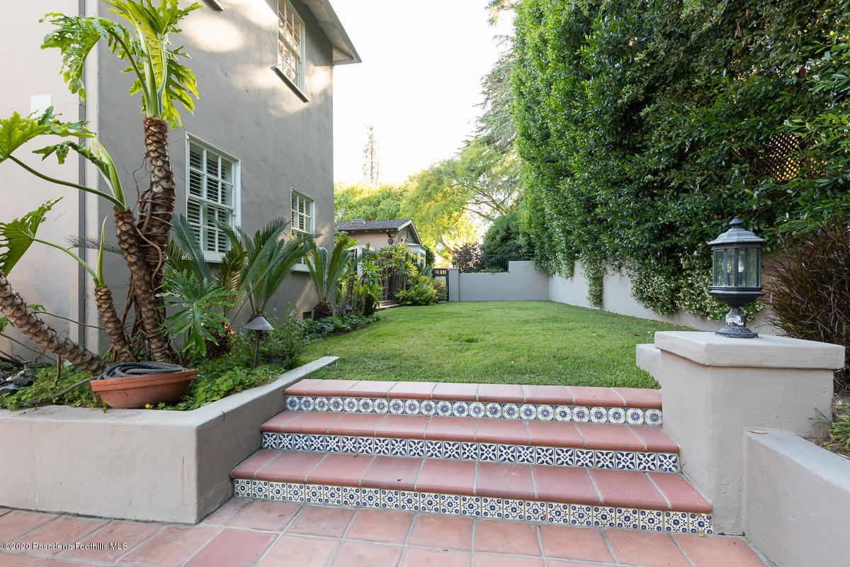 153 Sierra View Road Pasadena, CA 91105 - Photo 47 of 54 a view of a white house with a small yard plants and a fountain