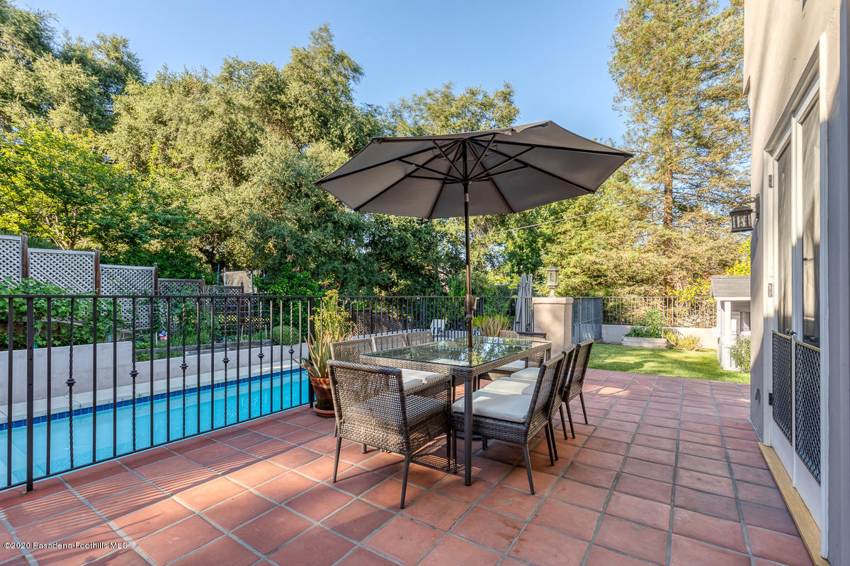 153 Sierra View Road Pasadena, CA 91105 - Photo 50 of 54 a view of a patio with a table and chairs under an umbrella