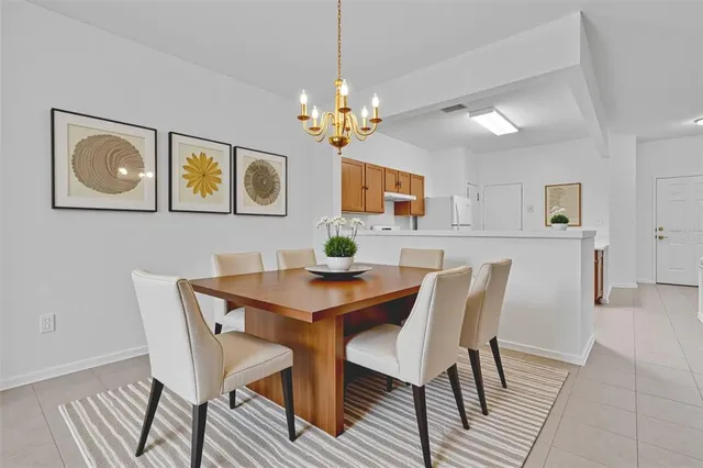 a view of a dining room with furniture and chandelier