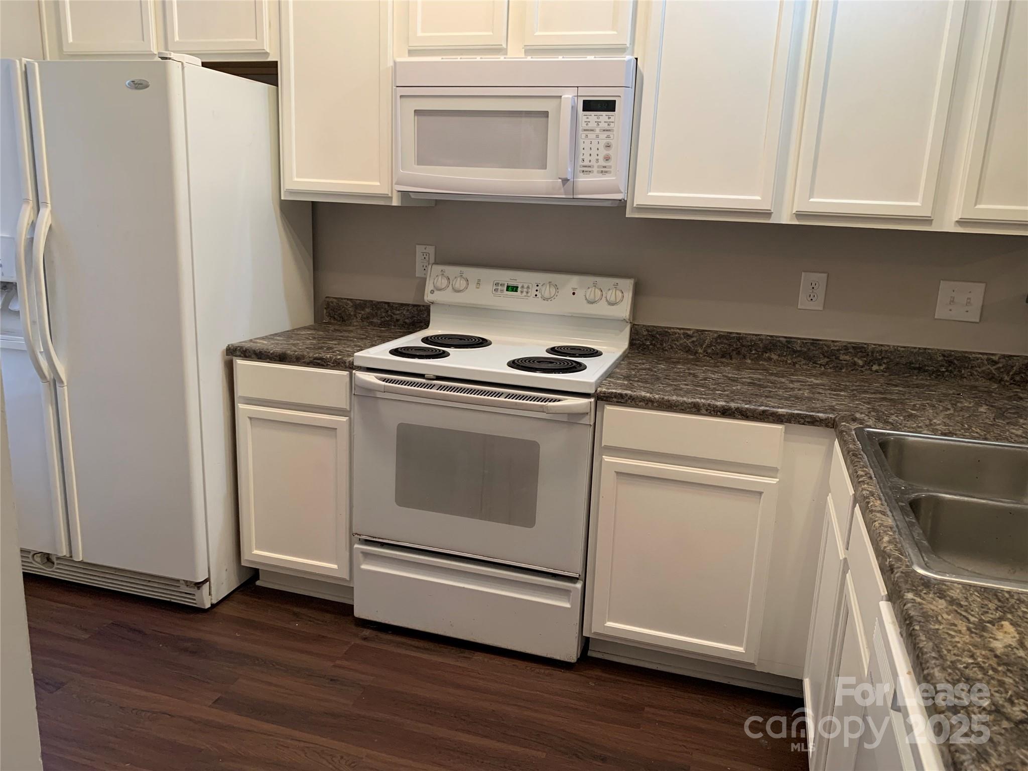 2726 Avalon Loop Road Charlotte, NC 28269 - Photo 5 of 12 a kitchen with granite countertop white cabinets and white appliances