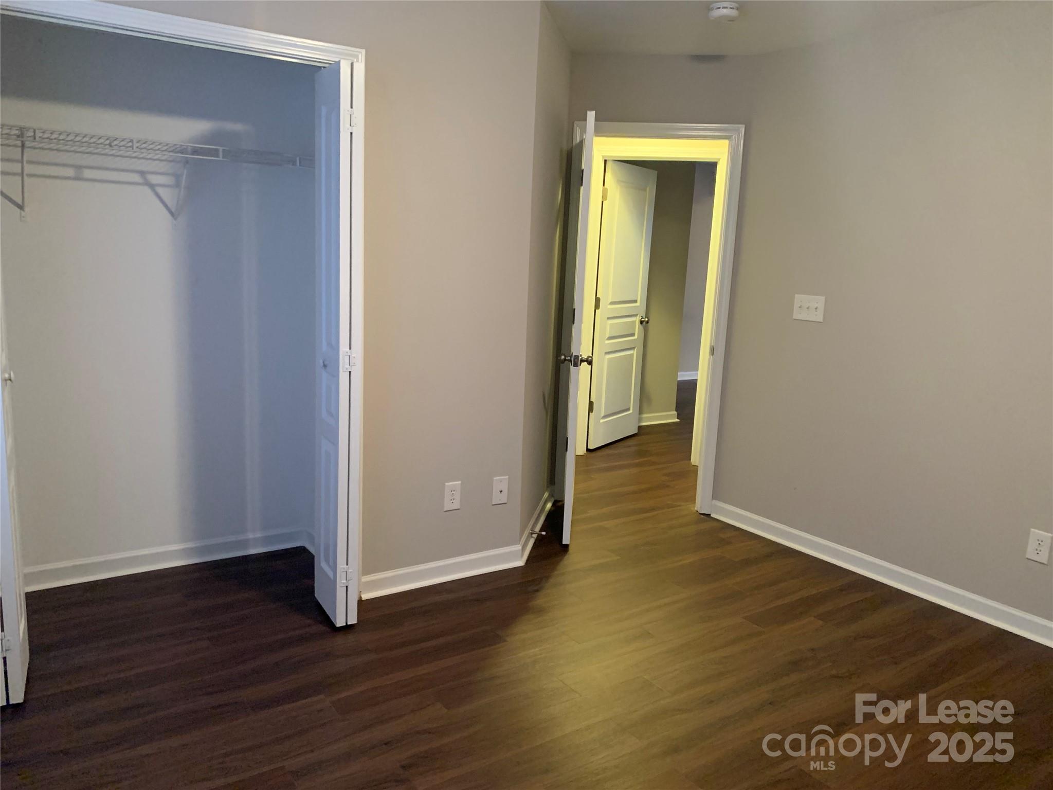 2726 Avalon Loop Road Charlotte, NC 28269 - Photo 7 of 12 an empty room with wooden floor and closet