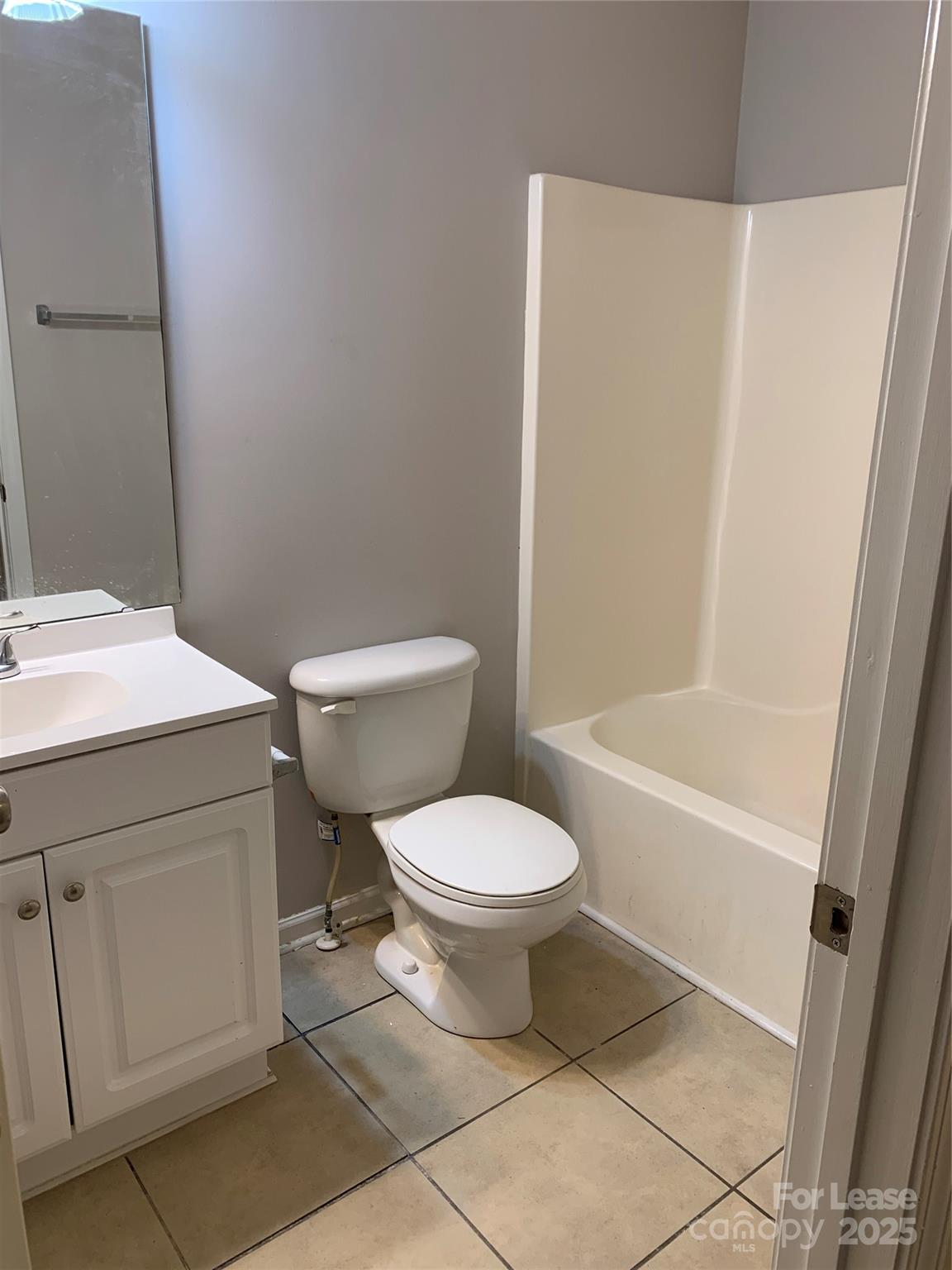 2726 Avalon Loop Road Charlotte, NC 28269 - Photo 8 of 12 a white toilet sitting next to a bathroom sink and vanity