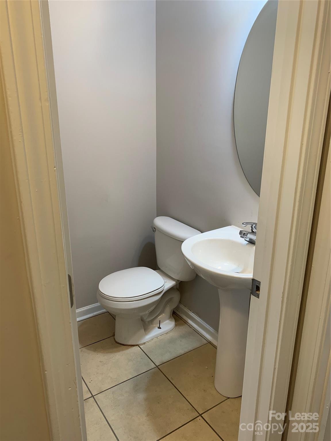 2726 Avalon Loop Road Charlotte, NC 28269 - Photo 10 of 12 a white toilet sitting next to a small sink