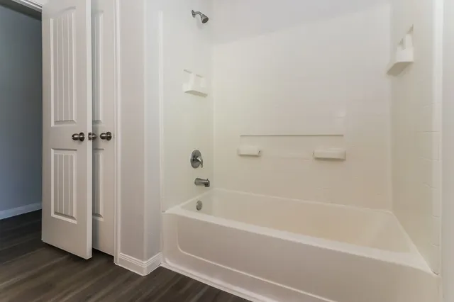 a white bath tub sitting next to a white wooden tub