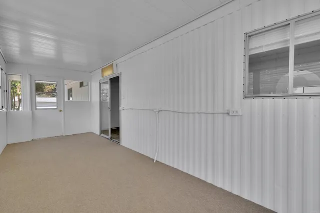 a view of empty room with large windows