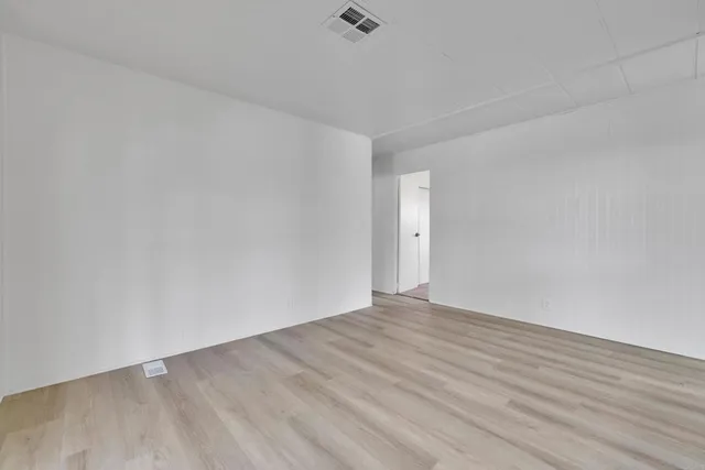 a view of hallway with wooden floor