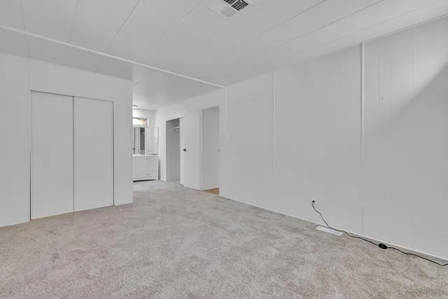 a bedroom with a bed and glass window