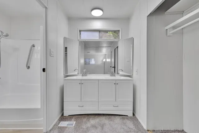 a bathroom with a shower a toilet and a shower