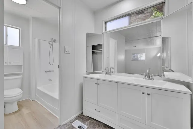 a view of a porch with a table and chairs and potted plants