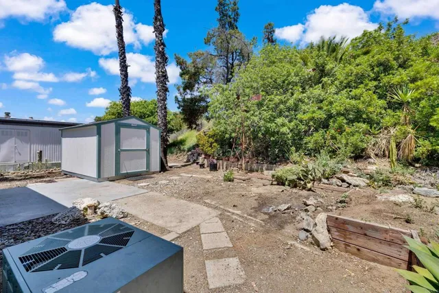 a view of a street with flower plants in front of main door