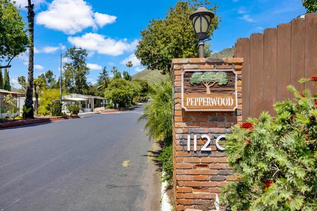 a view of a swimming pool with a patio and a yard