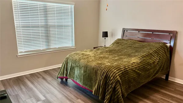 a bed sitting in a bedroom next to a window