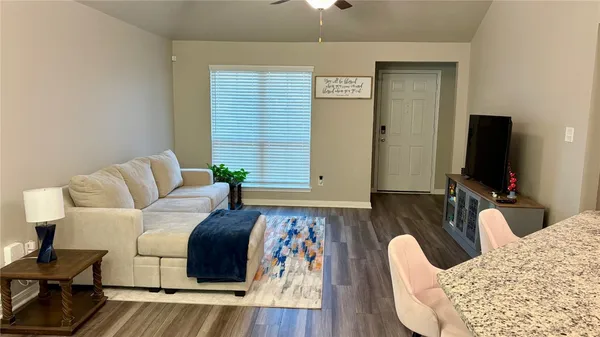 a living room with furniture and a flat screen tv
