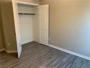 a view of walk in closet with wooden floor