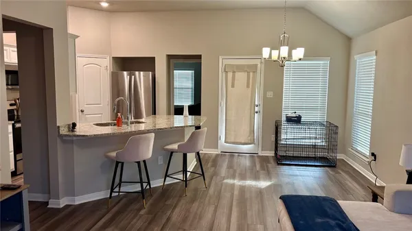 a view of a room with wooden floor and staircase