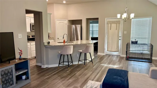 a view of a dining room with furniture and wooden floor