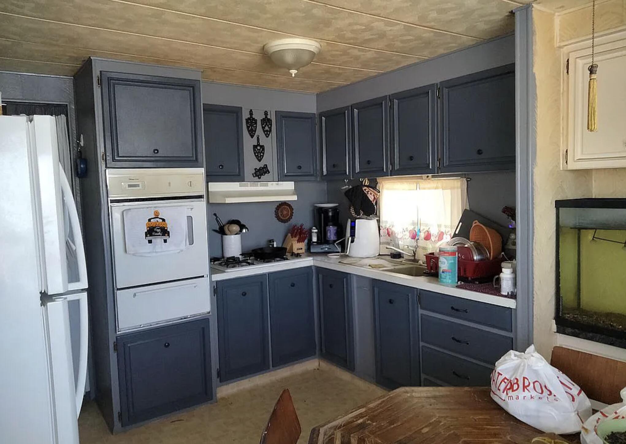 6426 Valley View Street Joshua Tree, CA 92252 - Photo 8 of 15 a kitchen with stainless steel appliances granite countertop a refrigerator sink and cabinets