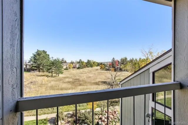 a view of a yard with an ocean and trees