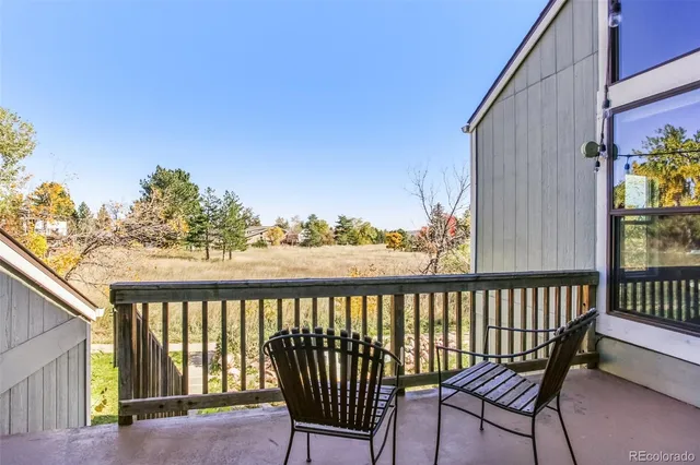 a view of a balcony with wooden floor and outdoor space