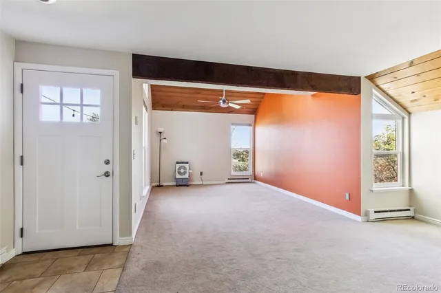 an empty room with sliding door and wooden floor