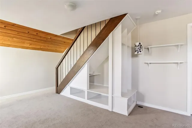 a kitchen with stainless steel appliances granite countertop a refrigerator a sink dishwasher a stove and white countertops with wooden floor